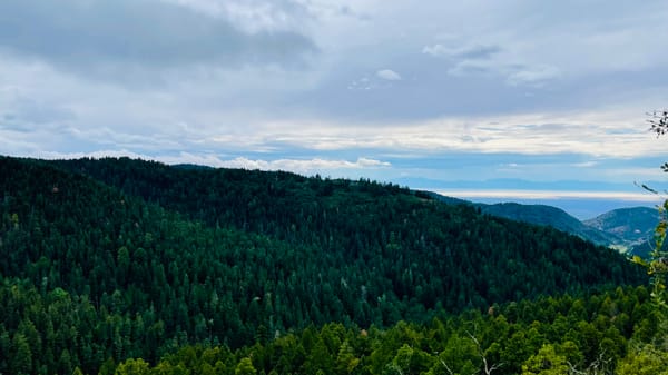 Mountain top view from the Lincoln National forrest, Cloudcroft, NM. Tree covered mountains with a view of White Sands.